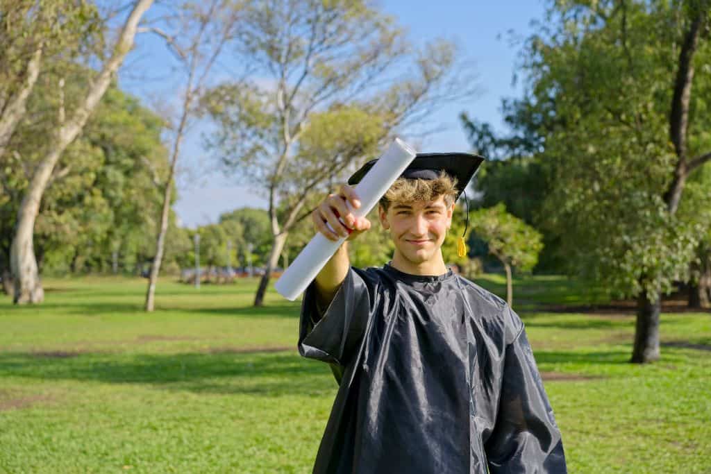 Graduate holding his degree